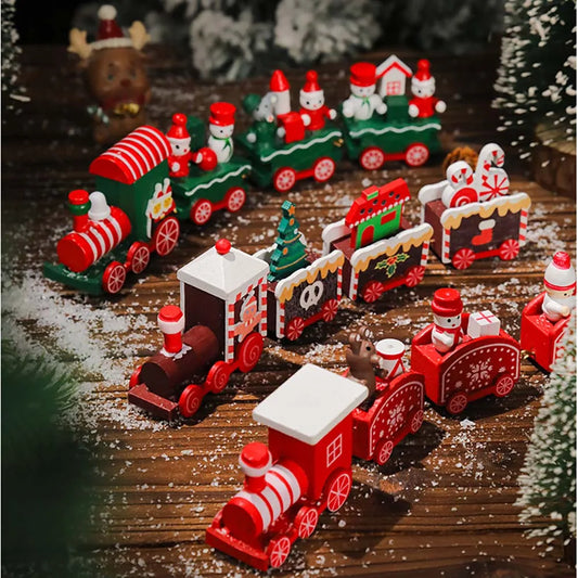 Set of miniature Christmas trains on a wooden surface with decorative elements.