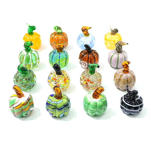 Collection of colorful glass pumpkins on a white background