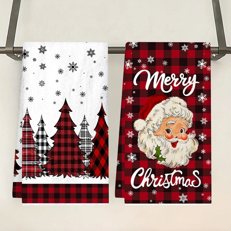 Two Christmas-themed kitchen towels with Santa Claus and tree designs on a rack.