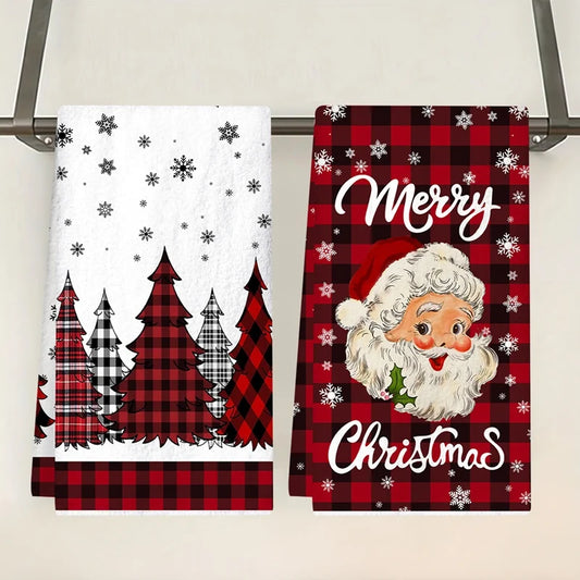 Two Christmas-themed kitchen towels with Santa Claus and tree designs on a rack.