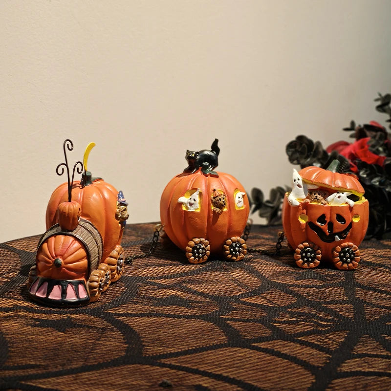 Three Halloween-themed pumpkin figurine train on a textured surface with a neutral background.