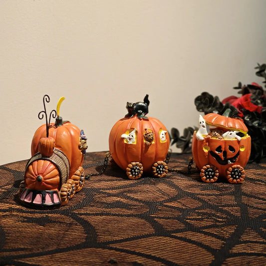 Three Halloween-themed pumpkin figurine train on a textured surface with a neutral background.