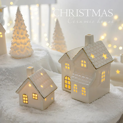 Decorative ceramic houses with glowing lights on a snowy background, labeled 'Christmas'.