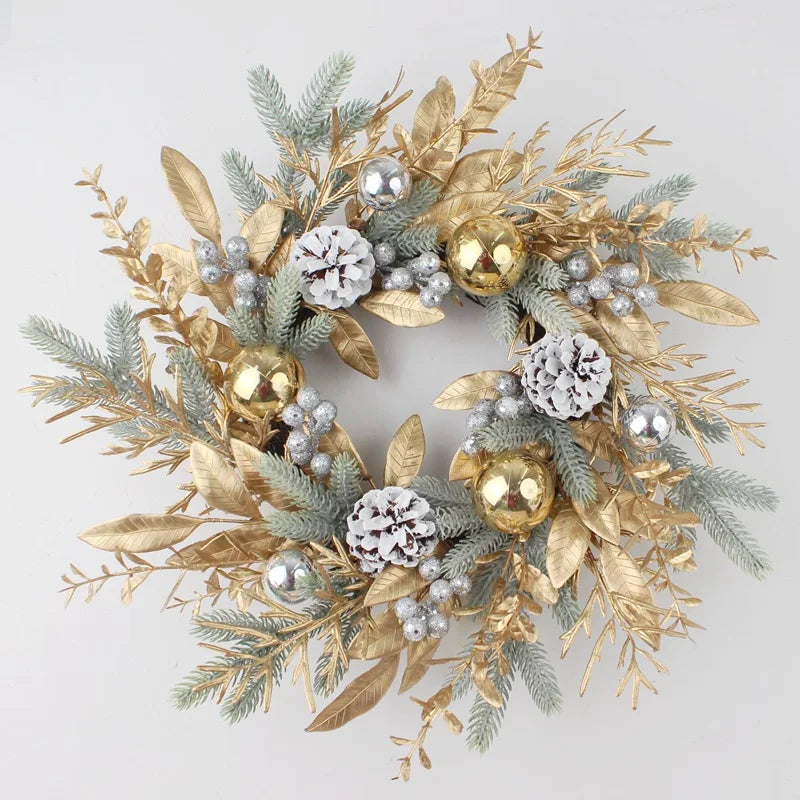 Decorative wreath with gold leaves, silver berries, and gold balls on a light gray background