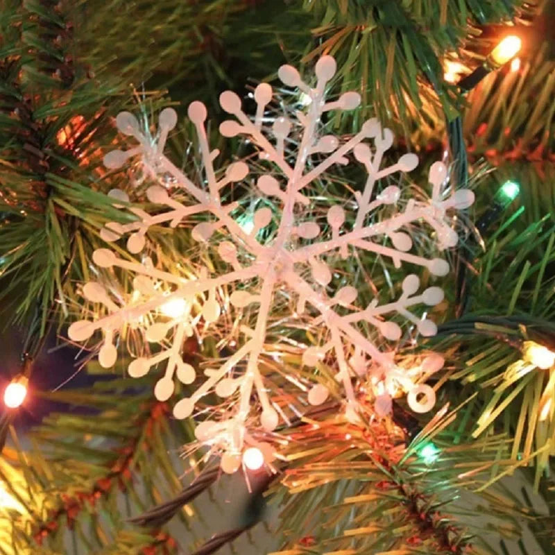 Decorative snowflake light on a Christmas tree with warm glow
