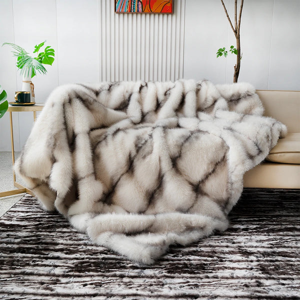 Fur throw blanket draped over a sofa in a living room setting with plants and decor.