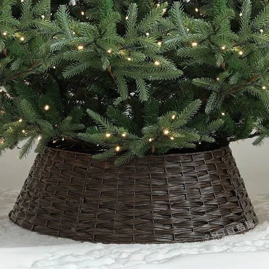 Woven rattan Christmas tree collar under a decorated tree with warm white lights.