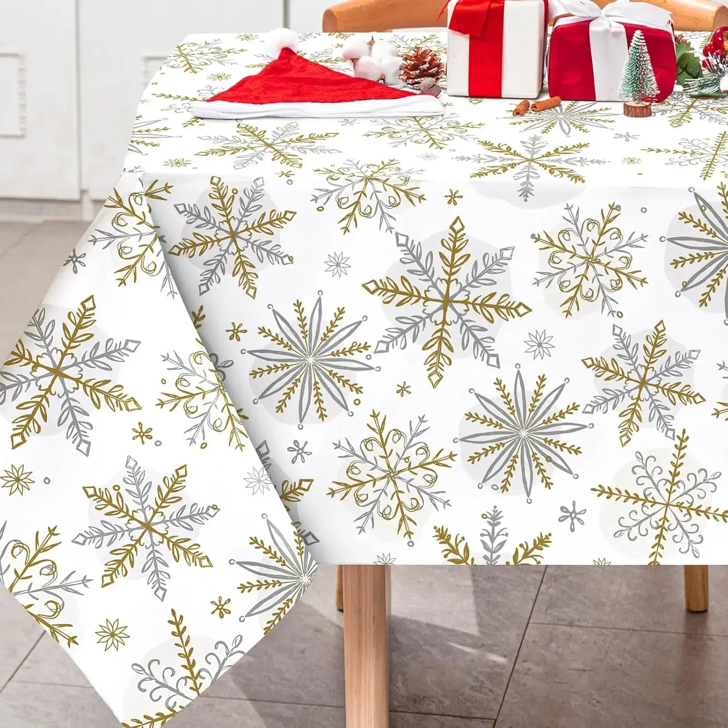 Tablecloth with snowflake pattern on a table, with Christmas decorations in the background.